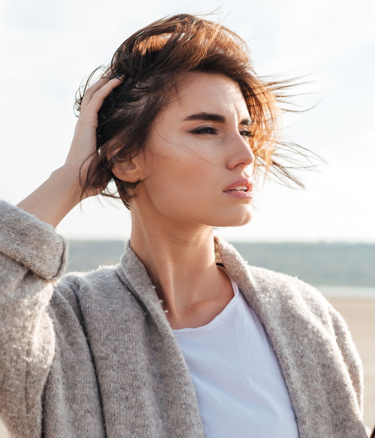 Woman with windswept hair on a sunny day.