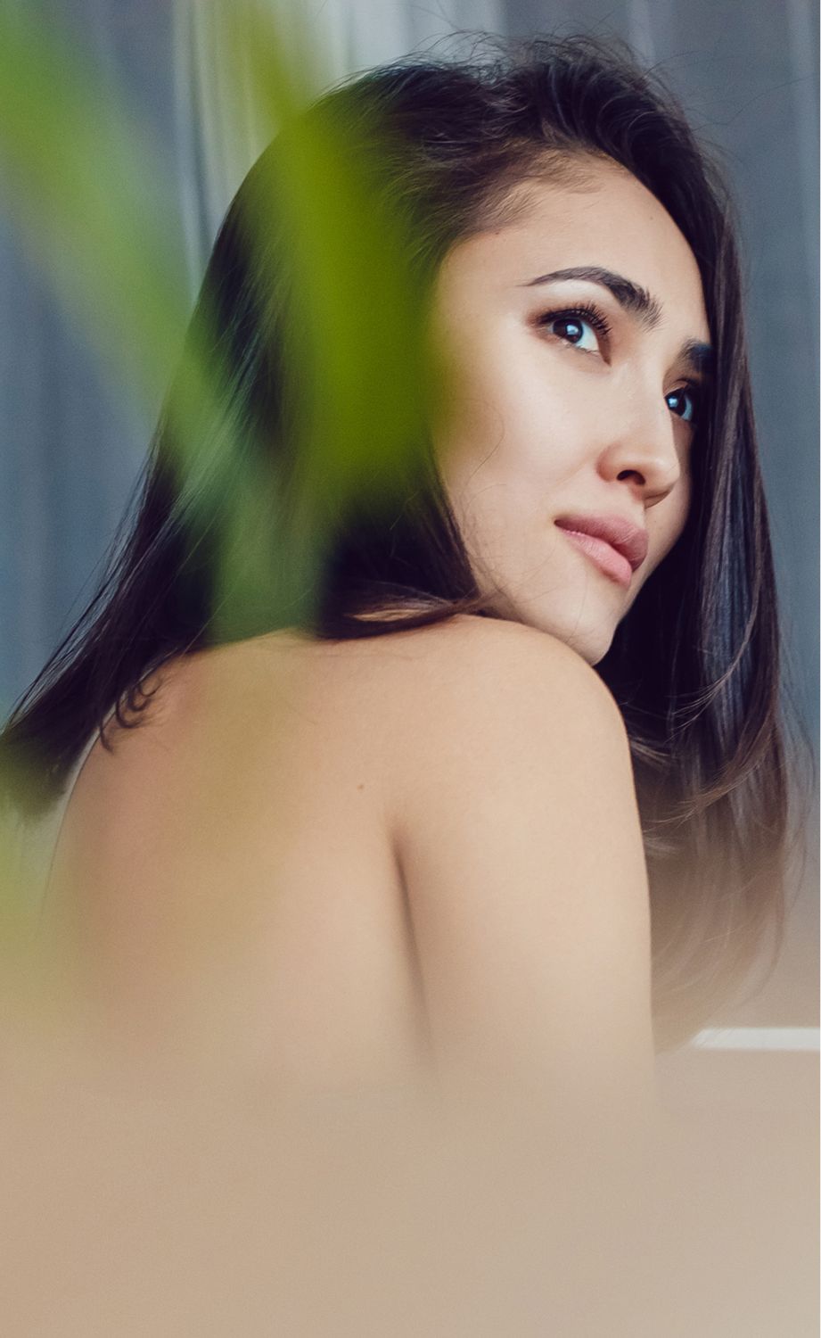 Woman gazing over her shoulder with soft lighting.