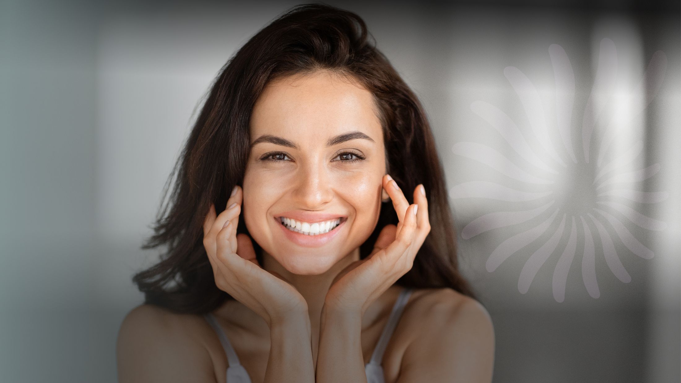 Smiling woman with hands on her face.